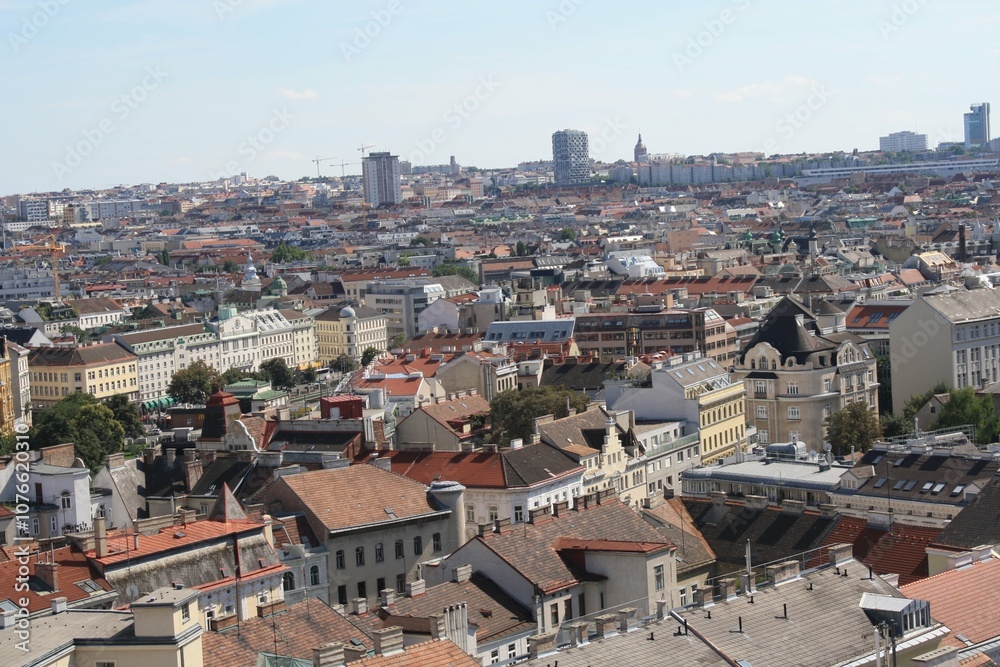 A panoramic view of the urban landscape in Vienna showcasing rooftops and modern architecture on a sunny day A panoramic view of the urban landscape in Vienna showcasing rooftops and modern architecture on a sunny day