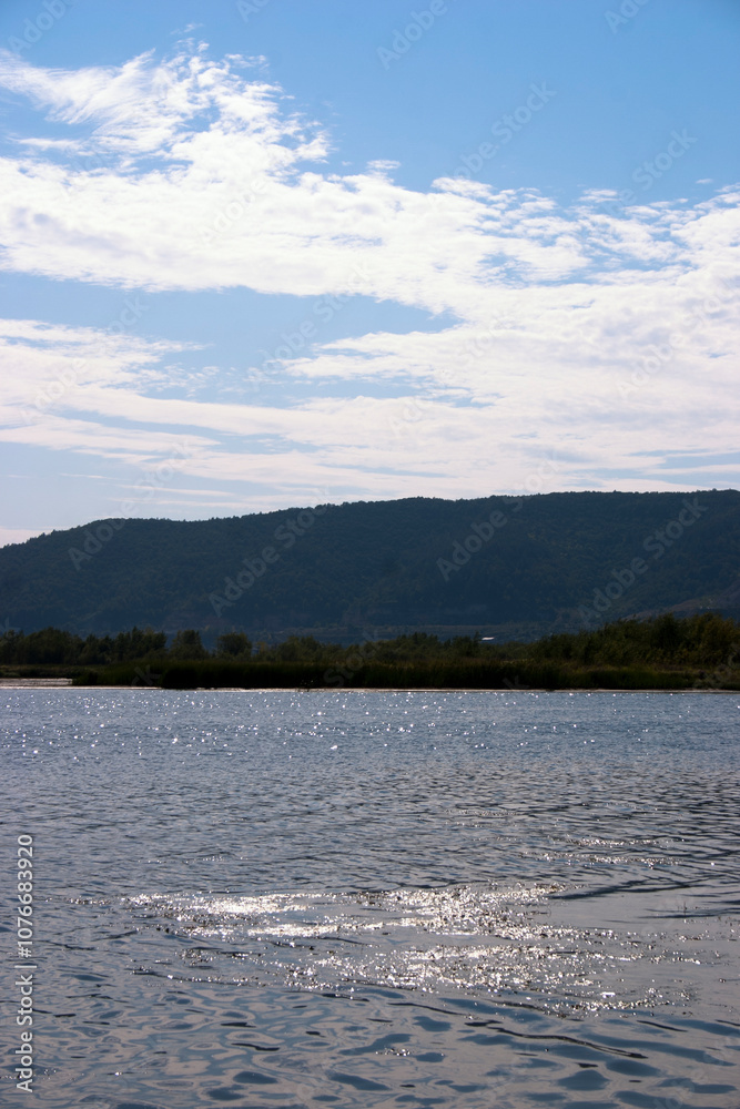 landscape of lake and blue sky with white clouds on a sunny day landscape of lake and blue sky with white clouds on a sunny day