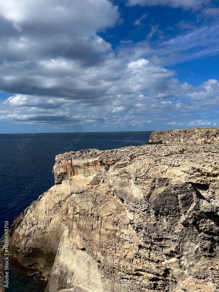 Rocky Cliff Overlooking the Ocean with Dramatic Sky Rocky Cliff Overlooking the Ocean with Dramatic Sky
