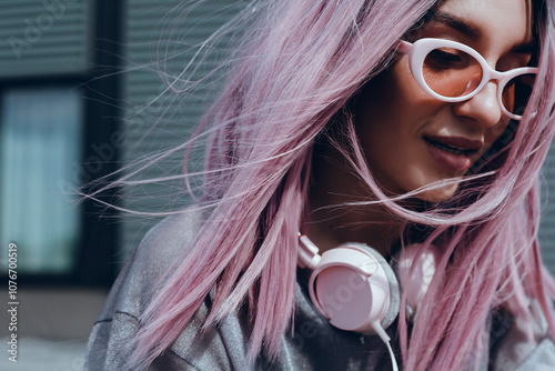 Young beauty girl purple hair make selfie on smartphone, happy face, outdoor hipster portrait on the street, smile happy face, listen music on headphones, Amsterdam street, dance, player,photo concept