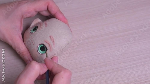 The master draws a doll's face