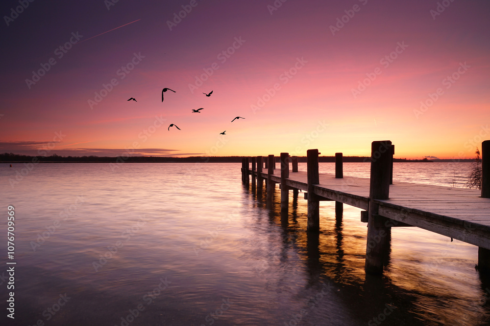 wooden pier over the calm sea, tranquil morning with beautiful sunrise, peaceful and quiet wooden pier over the calm sea, tranquil morning with beautiful sunrise, peaceful and quiet