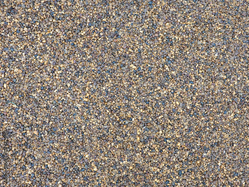 Many small smooth gray and sandy brown pebble stones as background top view close up