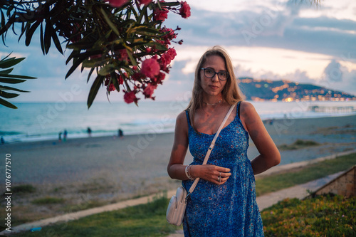 Woman sits on the beach and...