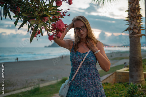 Woman sits on the beach and...