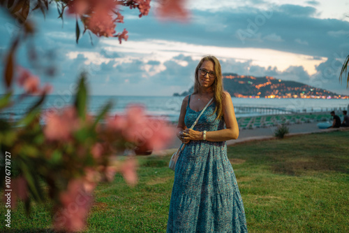 Woman sits on the beach and looks at the sea in Alanya city