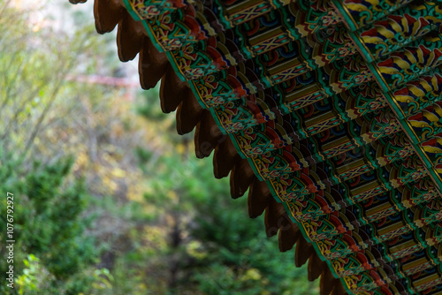 eaves and roof with traditional Korean paintings in the Buddhist temple building photo