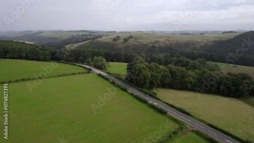 Running along a rainy Scottish main road by drone