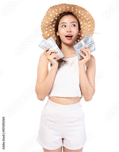 Young woman in a straw hat holding money, joyful expression, isolated on white background. photo