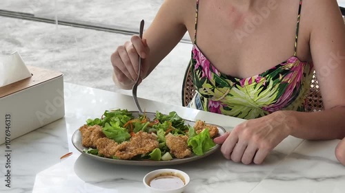 A woman is relishing a delightful meal and drinks in a modern cafe  photo