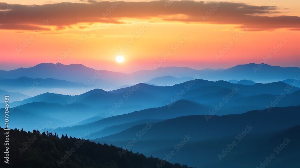 Obraz premium Sunrise over a mountain range with a layer of mist creating a serene, peaceful and inspiring image.