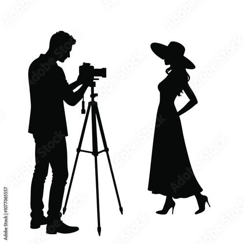 A silhouette of a cameraman operating a standing camera on a tripod,