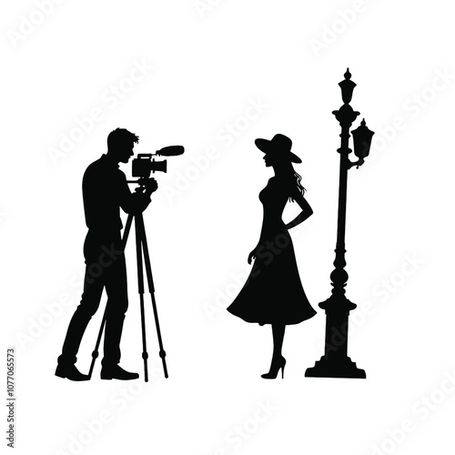 A silhouette of a cameraman operating a standing camera on a tripod,