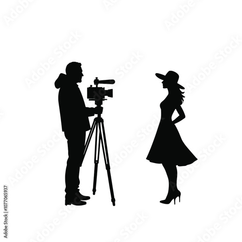 A silhouette of a cameraman operating a standing camera on a tripod,