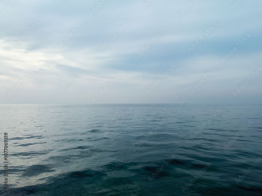Fototapeta premium Calm sea under a sunset sky. waterline. sea water surface. mockup. product display. minimalistic. abstract background. horizontal