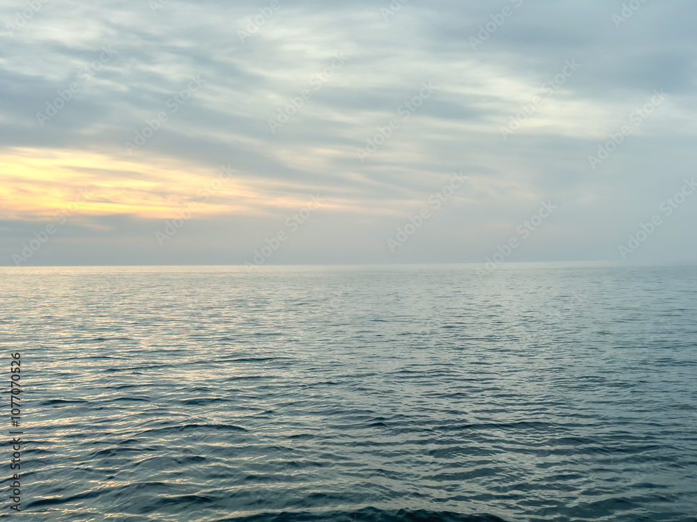 Fototapeta premium Calm sea under a sunset sky. waterline. sea water surface. mockup. product display. minimalistic. abstract background. horizontal