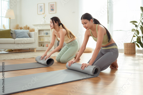 Wallpaper Mural Asian young woman rolling yoga mat after exercise Torontodigital.ca