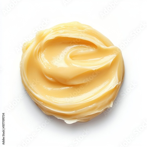 Smooth swirl of natural yellow shea butter isolated on a white background photo