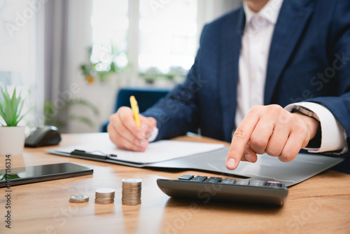 Business accounting concept, man using calculator