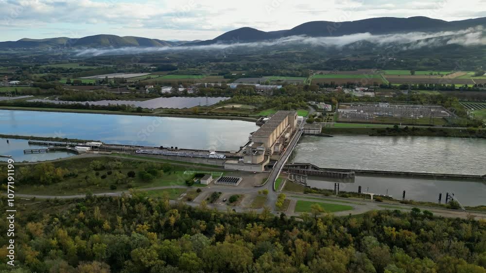 Saulce sur Rhone, France - 27 October 2024: Industrial ship passing through the lock above the hydroelectric power plant on the Rhone river in the Drome district of France