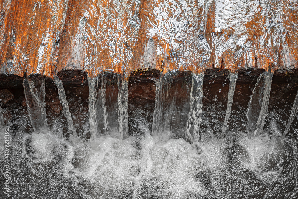 River streams flowing over logs. River streams flowing over logs. Creek rapids made of logs.
