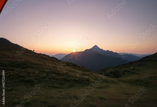 Camping view from the tent of the mountain landscape during sunset or sunrise