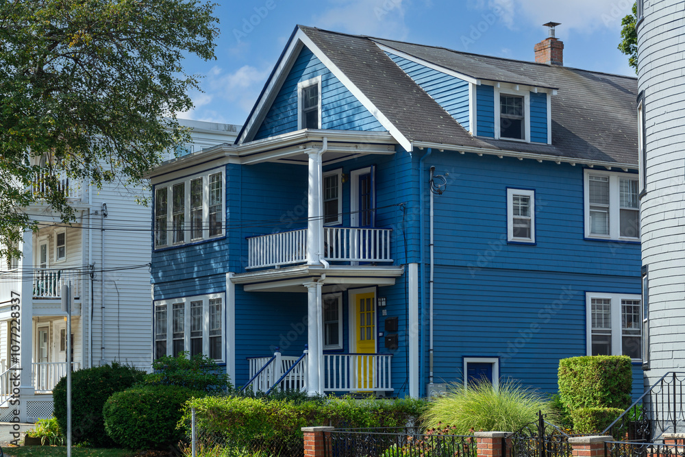 Fototapeta premium Blue clapboard family house with dormer window and balcony in Brighton, Massachusetts, USA