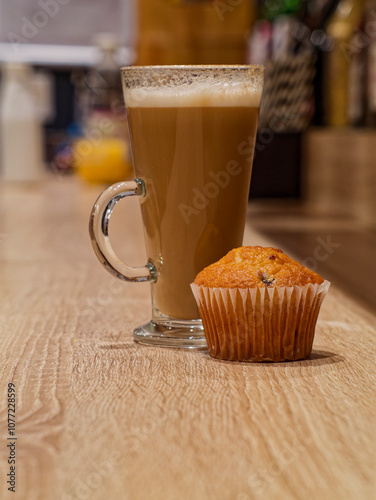 Glass cup of latte and a blueberry muffin