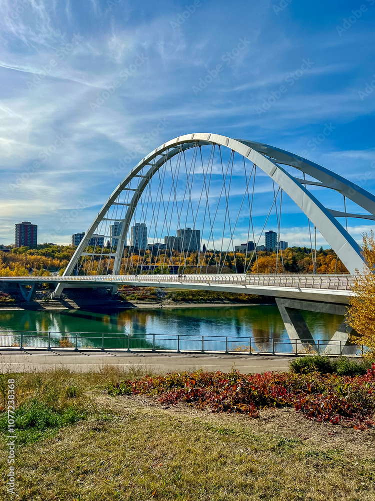 Fototapeta premium Edmonton, Alberta - October 13, 2024: Views of the Edmonton skyline with the Walterdale Bridge over the North Saskatchewan River in the foreground 