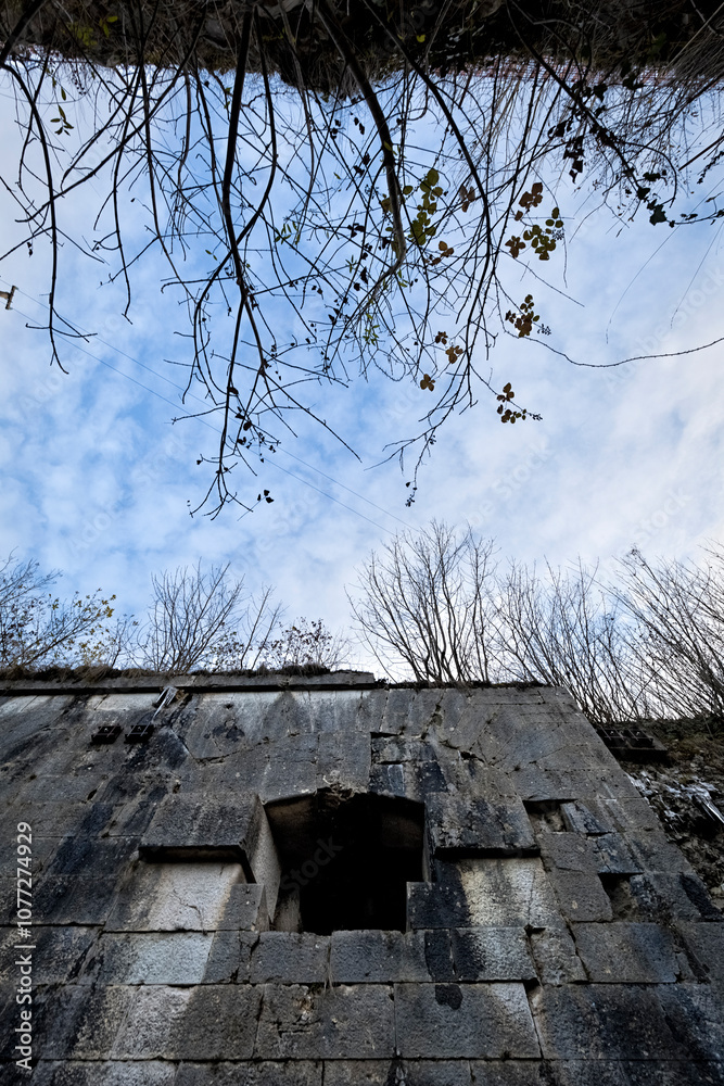 Tagliata delle Fontanelle: a cannon opening in the wall of the nineteenth-century fortress. Fastro Bassanese, Valbrenta, Veneto, Italy.