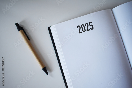 2025 calendar book and pencil on desk