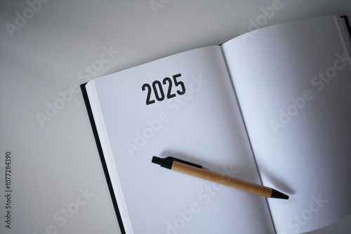 2025 calendar book and pencil on desk