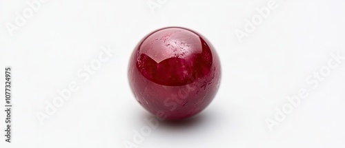 A single, smooth, red gemstone sphere, with a slight sheen, on a white background. photo