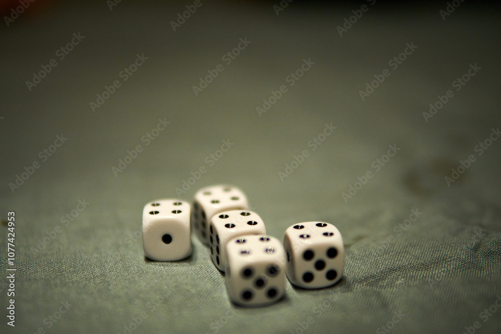 Group of six dice arranged neatly on a green tablecloth during a casual game night with friends at home Group of six dice arranged neatly on a green tablecloth during a casual game night with friends at home