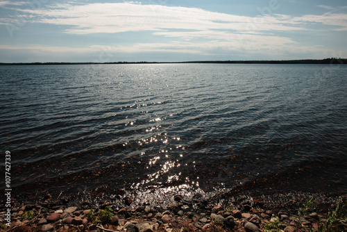 Looking west over Trout Lake, near Boulder Junction, Wisconsin, in Vilas County, in late June, just as the late afternoon sun starts is descent toward the horizon photo