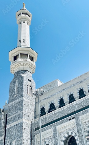 The white minarets of the masjid al harram with a clear blue sky photo