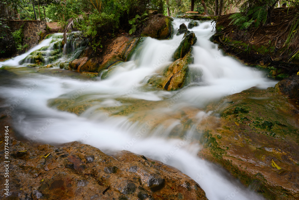 Fototapeta premium Soa Hot Spring Waterfall in Mangeruda, Flores, Indonesia with Thermal Water Flowing over Rocks