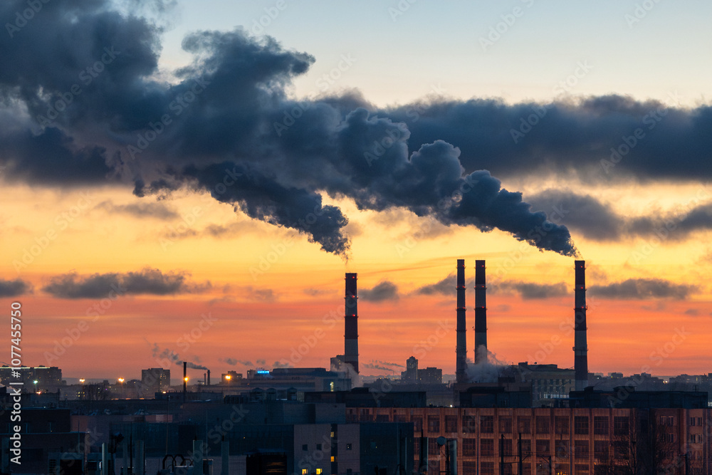 Smoke from factory pipe of heat station in the city in winter time. Fuel oil or natural gas-fired power plant. Air pollution. Chimneys, environmentally unfriendly, using coal for heating season. Smoke from factory pipe of heat station in the city in winter time. Fuel oil or natural gas-fired power plant. Air pollution. Chimneys, environmentally unfriendly, using coal for heating season.