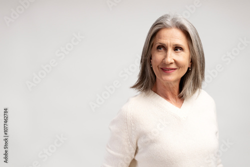 Portrait of smiling, beautiful senior woman looking away on copy space, mature female