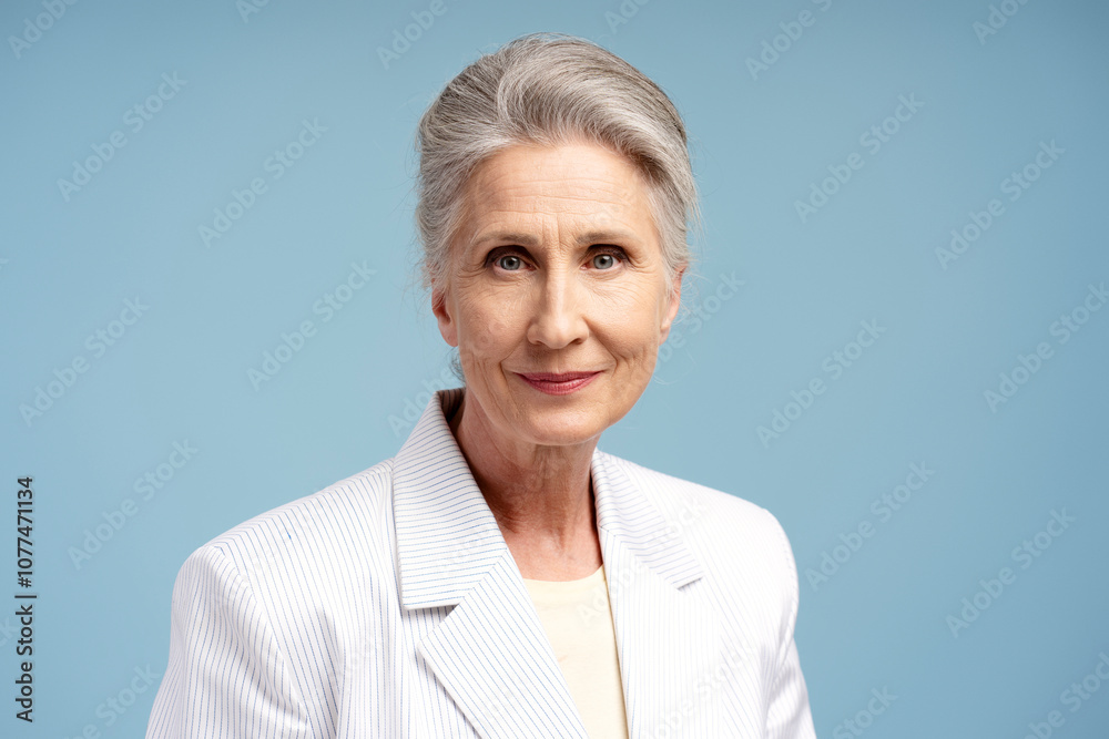 Portrait of smiling, beautiful senior woman, successful businesswoman wearing stylish suit Portrait of smiling, beautiful senior woman, successful businesswoman wearing stylish suit
