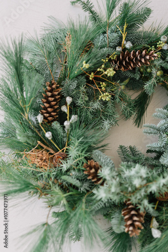 Close-up of a pine wreath with pine cones and greenery photo