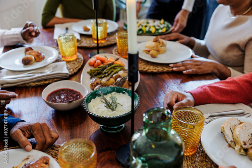 Family gathering enjoying thanksgiving meal around a table photo