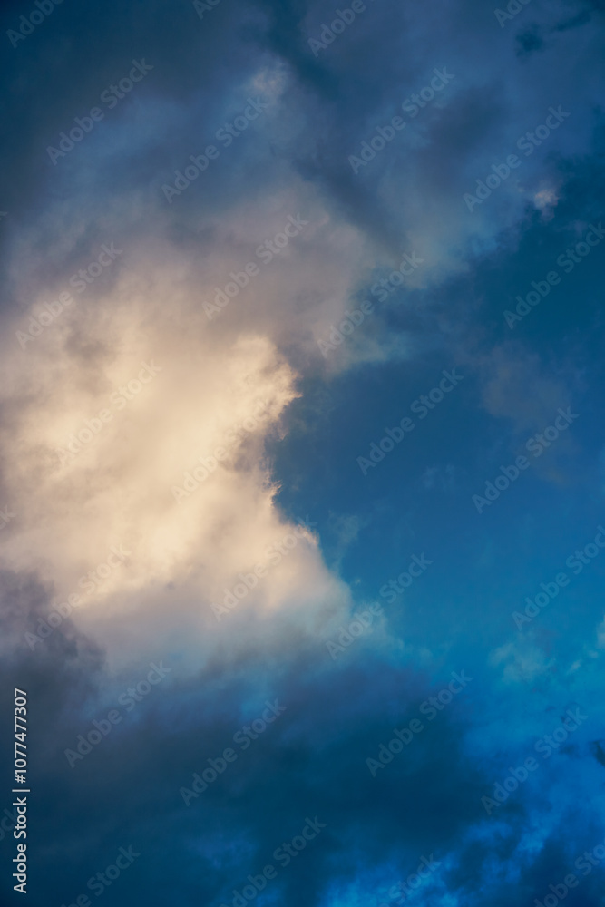 Dramatic cloud formations illuminated by soft light during the early evening in a tranquil sky Dramatic cloud formations illuminated by soft light during the early evening in a tranquil sky