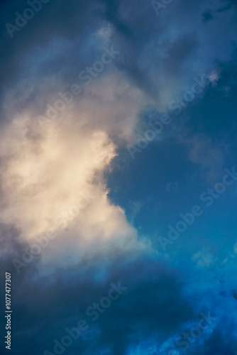 Dramatic cloud formations illuminated by soft light during the early evening in a tranquil sky