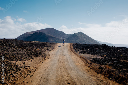 Sporty man hiking through the rugged volcanic landscapes of Lanzarote photo