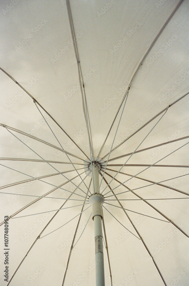 Film photography. White parasol and shadow pattern. Minimal Film photography. White parasol and shadow pattern. Minimal