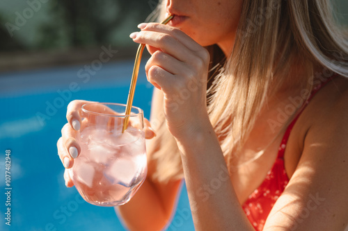 Sipping a drink by the sunny poolside