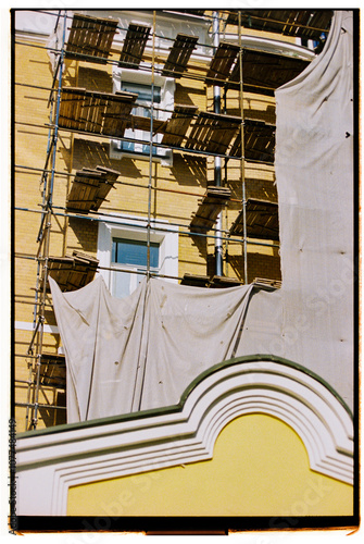 Construction site featuring scaffolding on a building renovation. photo