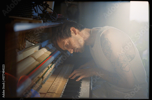 The musician plays the piano sensually photo