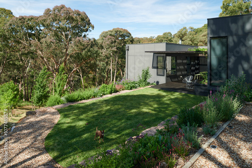 Modern home surrounded by nature with landscaped garden photo